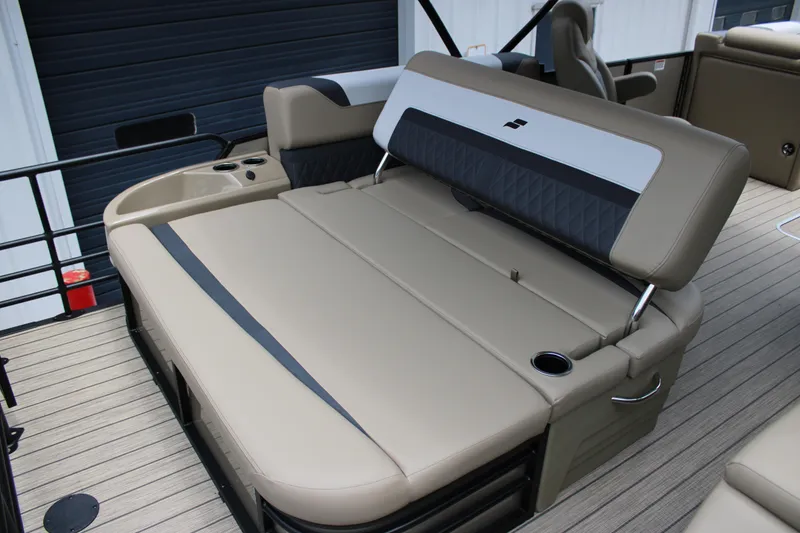 Slide: The Image of 2025 Starcraft SLS-3 Q DH boat interior with beige seating and cup holders. - 8