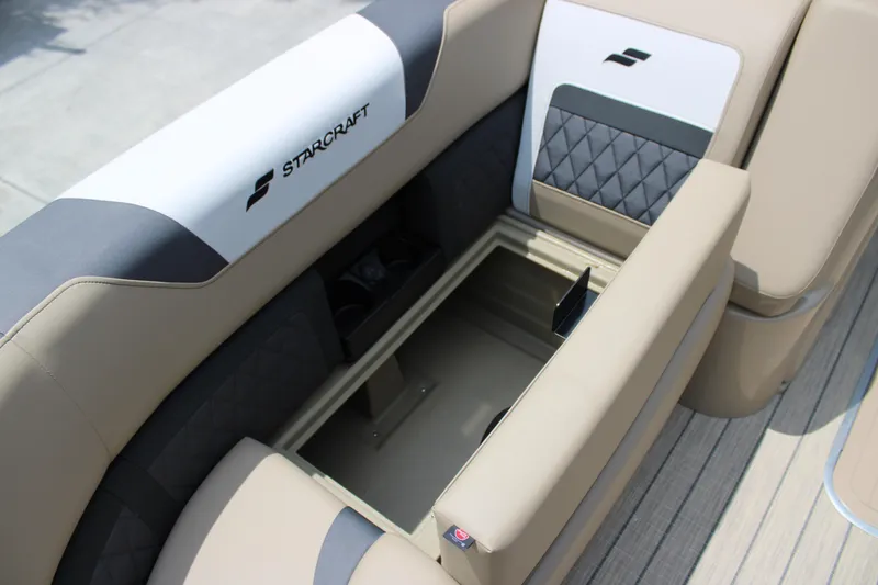 Slide: The Image of 2025 Starcraft SLS-3 Q DH boat interior with open storage compartment and cushioned seating. - 9