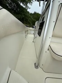 Slide: The Image of 2002 Hydra-Sports 2390 CC Vector boat interior, featuring sleek white design and seating. - 16