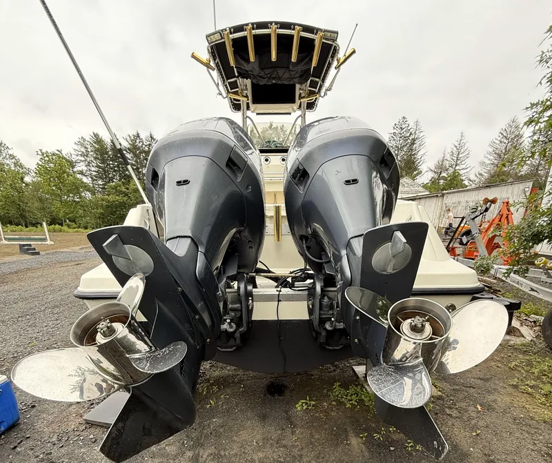 Slide: The Image of 2002 Hydra-Sports 2390 CC Vector boat with dual outboard motors, parked outdoors. - 19