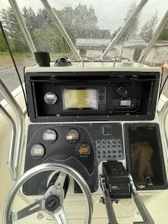 Slide: The Image of 2002 Hydra-Sports 2390 CC Vector boat dashboard with steering wheel and navigation instruments. - 2