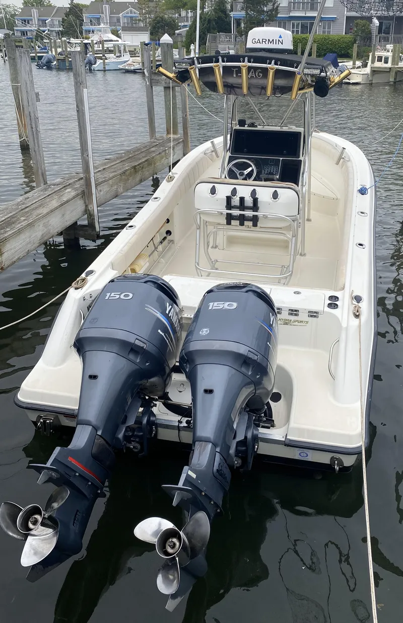 Slide: The Image of 2002 Hydra-Sports 2390 CC Vector boat with dual outboard motors docked in a marina. - 32