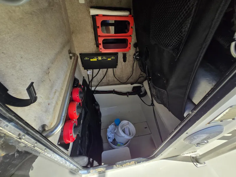 Slide: The Image of Interior of a 2002 Hydra-Sports 2390 CC Vector boat, showing storage and equipment. - 4