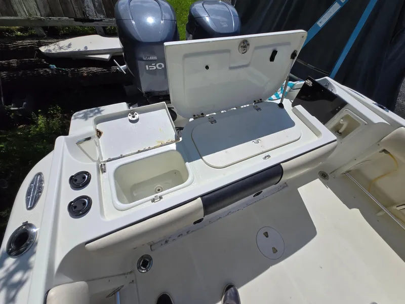 Slide: The Image of 2002 Hydra-Sports 2390 CC Vector boat interior with open storage compartments and dual Yamaha 150 engines. - 44