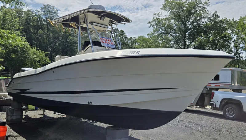 Slide: The Image of 2002 Hydra-Sports 2390 CC Vector boat for sale, parked on blocks, with trees in background. - 6