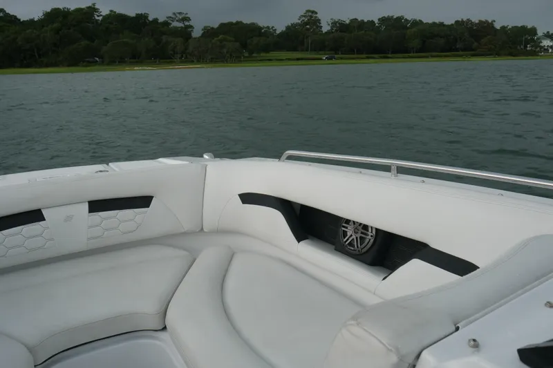 Slide: The Image of 2022 Four Winns HD5 OB boat interior with white seating and water view. - 12