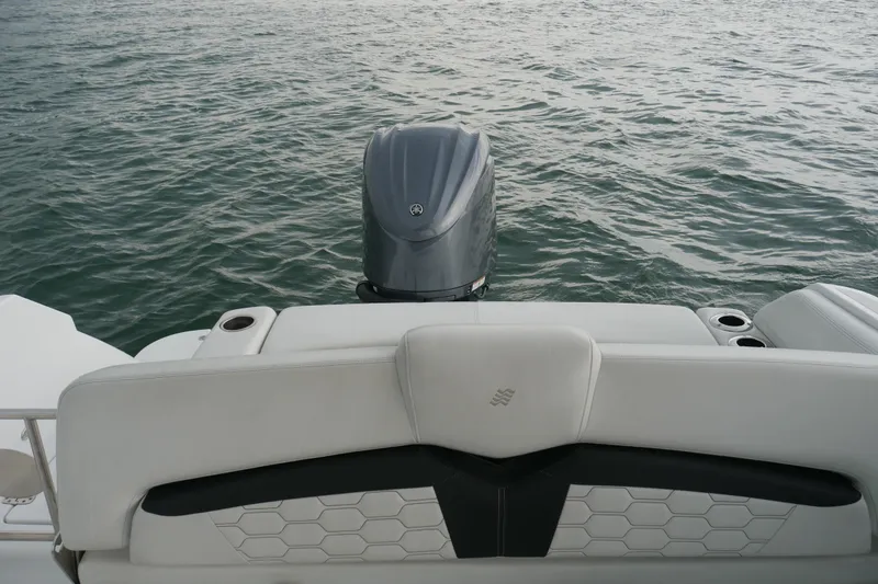 Slide: The Image of 2022 Four Winns HD5 OB boat with outboard motor on calm water. - 13
