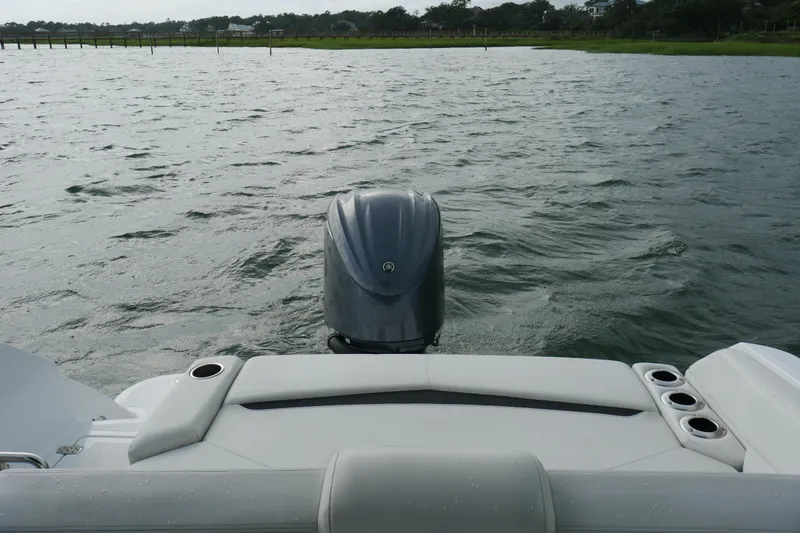 Slide: The Image of 2022 Four Winns HD5 OB boat with outboard motor on a calm lake. - 23
