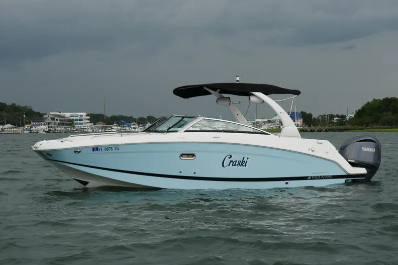 Slide: The Image of 2022 Four Winns HD5 OB boat on water, featuring sleek design and Yamaha outboard motor. - 7