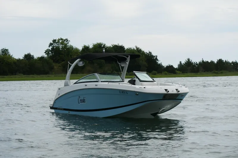 Slide: The Image of 2022 Four Winns HD5 OB boat on water, featuring sleek design and canopy. - 8