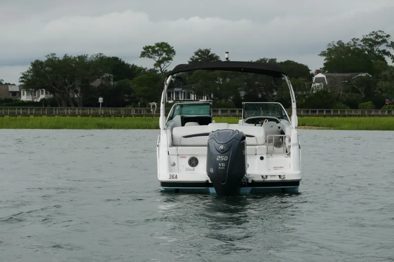 Slide: The Image of 2022 Four Winns HD5 OB boat on water, rear view with outboard motor. - 9