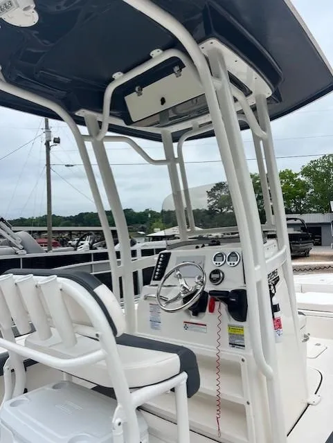 Slide: The Image of 2021 Robalo 226 Cayman boat console with steering wheel and gauges, featuring a T-top. - 3