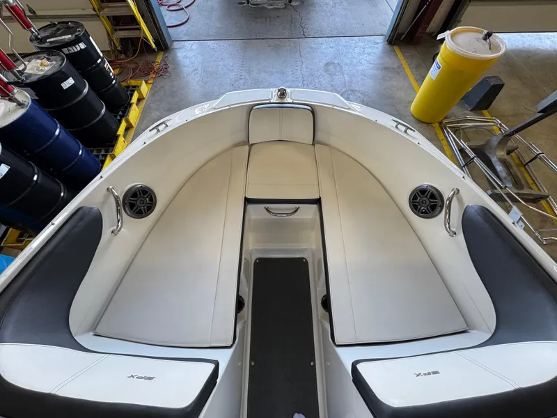 Slide: The Image of 2015 Sea Ray 190 Sport boat interior with white seating and speakers. - 3