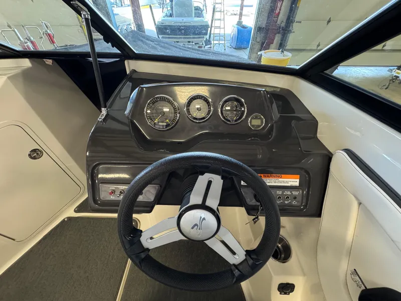 Slide: The Image of 2015 Sea Ray 190 Sport dashboard with steering wheel and instrument panel. - 5