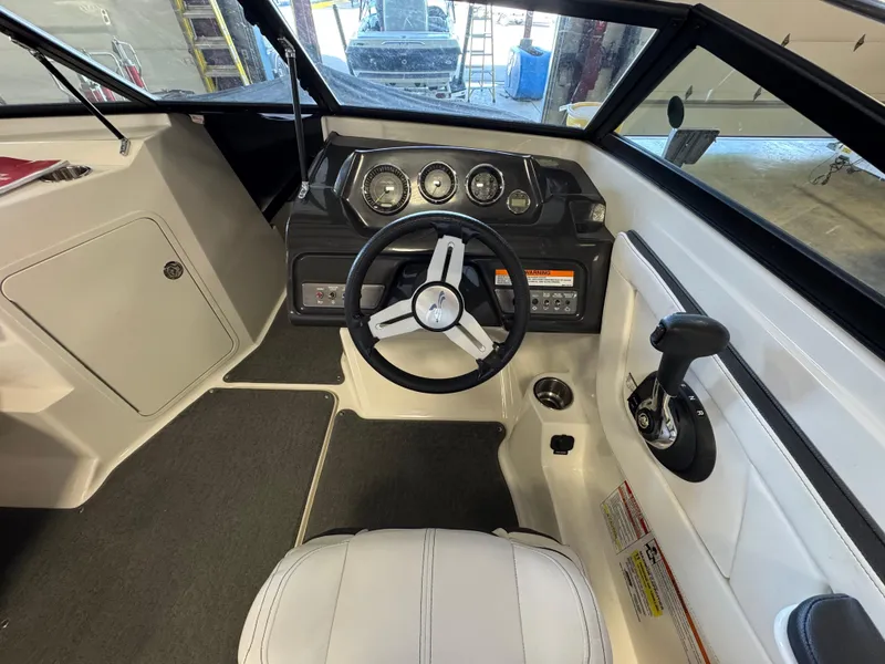 Slide: The Image of 2015 Sea Ray 190 Sport boat cockpit with steering wheel and control panel. - 6
