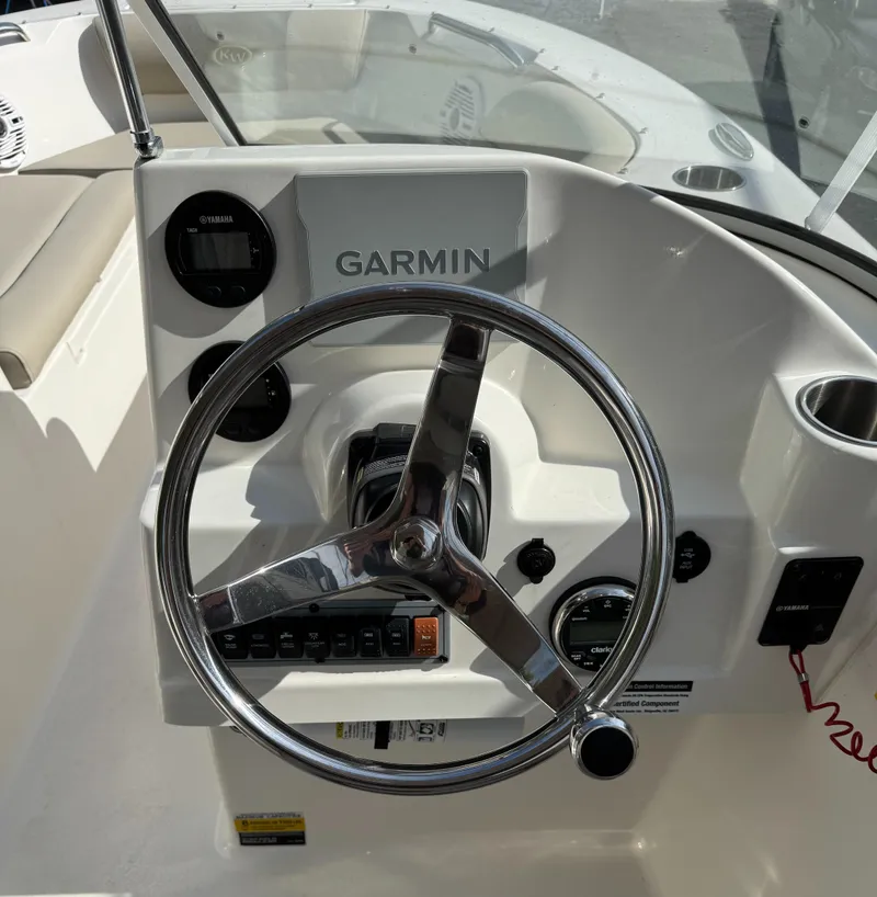 Slide: The Image of 2022 Key West 203 DFS boat dashboard with Garmin navigation system and steering wheel. - 10