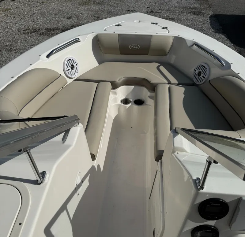 Slide: The Image of 2022 Key West 203 DFS boat interior with beige seating and cup holders. - 12