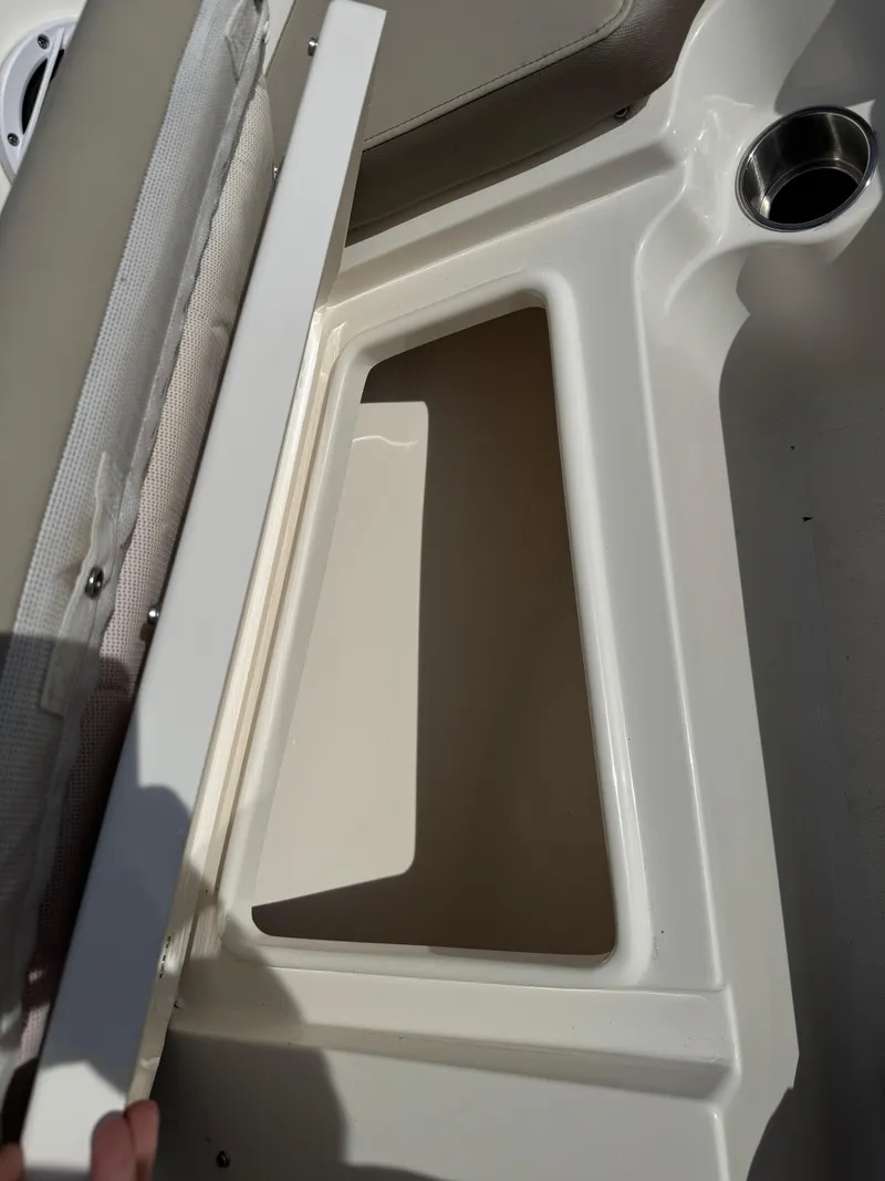 Slide: The Image of 2022 Key West 203 DFS boat storage compartment with cup holder. - 14