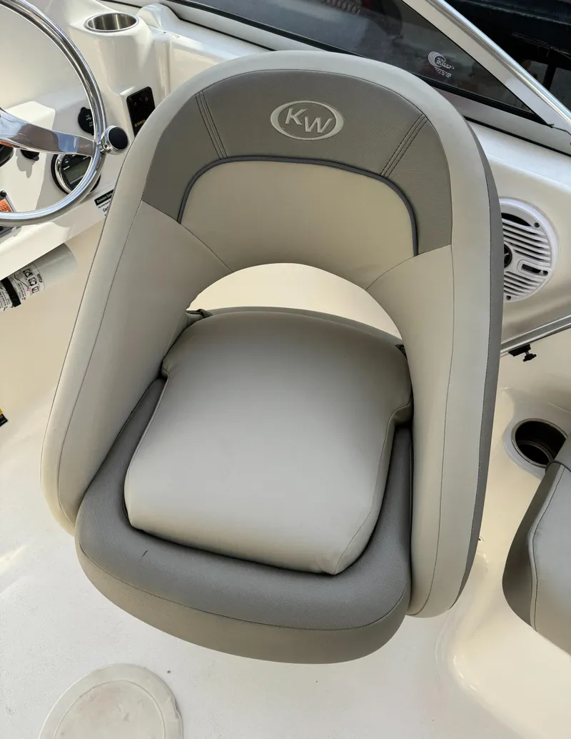 Slide: The Image of Key West 203 DFS 2022 boat seat, gray and white design, with steering wheel and cup holder nearby. - 18