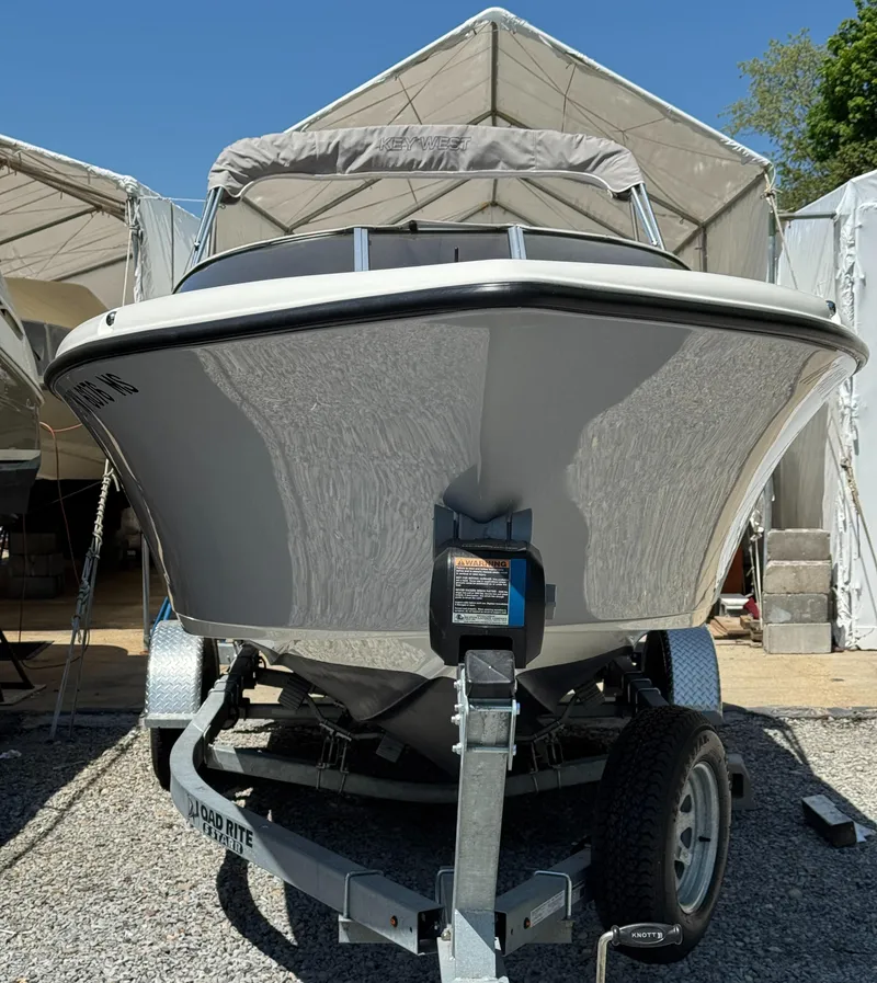 Slide: The Image of 2022 Key West 203 DFS boat on trailer, parked in a covered area. - 4
