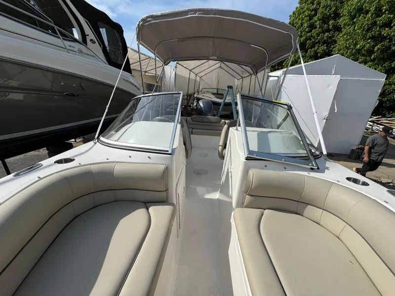 Slide: The Image of 2022 Key West 203 DFS boat with beige seating and canopy, docked outdoors. - 8