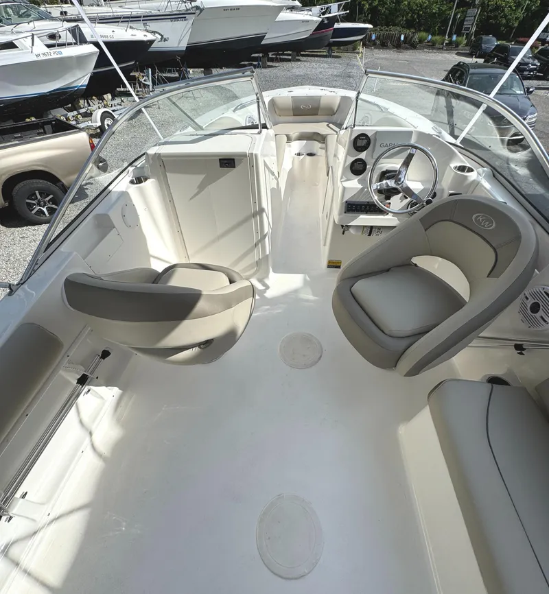 Slide: The Image of 2022 Key West 203 DFS boat interior with seating and steering wheel. - 9