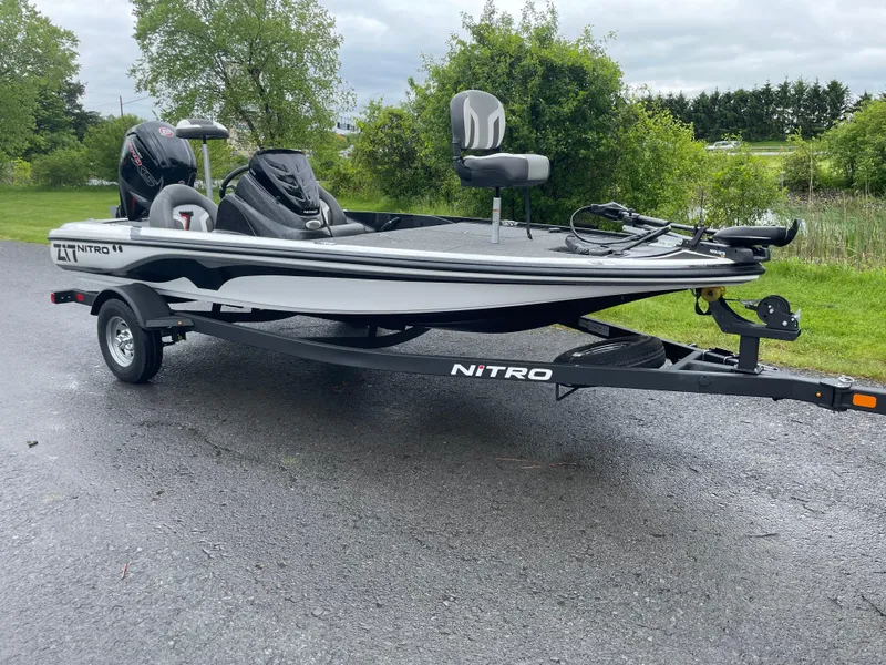 Slide: The Image of 2025 Nitro Z17 fishing boat on trailer, parked outdoors. - 1