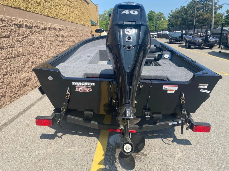 Slide: The Image of 2025 Tracker Super Guide V-16 T boat with 40 HP motor, parked outdoors. - 3