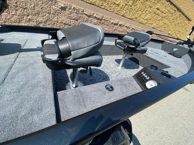 Slide: The Image of 2025 Tracker Super Guide V-16 T boat interior with two swivel seats and control panel. - 4