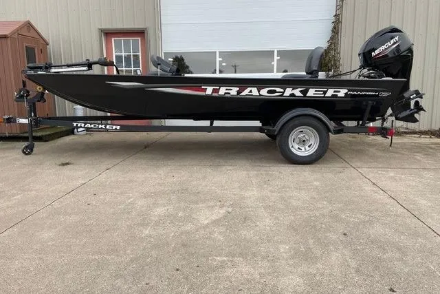 The Image of 2025 Tracker Panfish 17 boat on trailer, parked outdoors, featuring a Mercury outboard motor. - 0