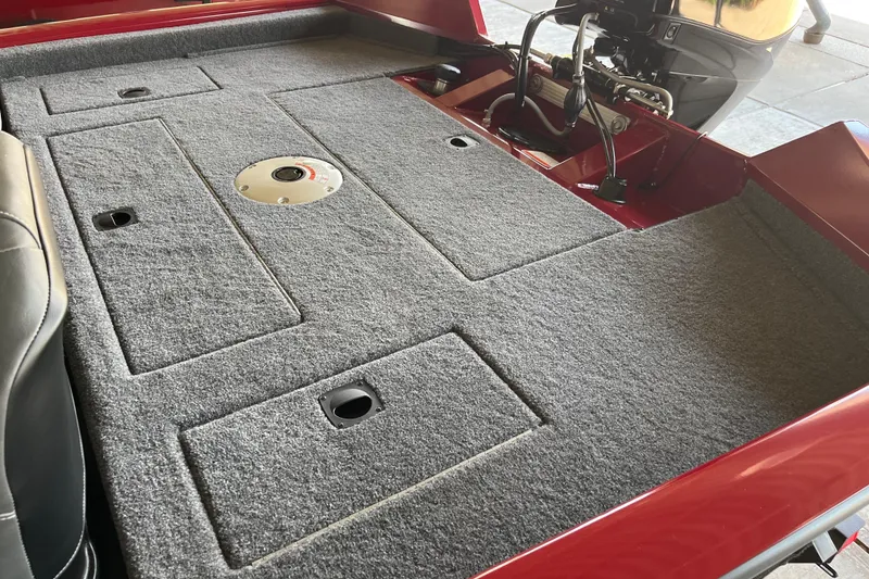 Slide: The Image of 2025 Tracker Pro Team 175 Crappie Edition boat interior with gray carpeted deck. - 3