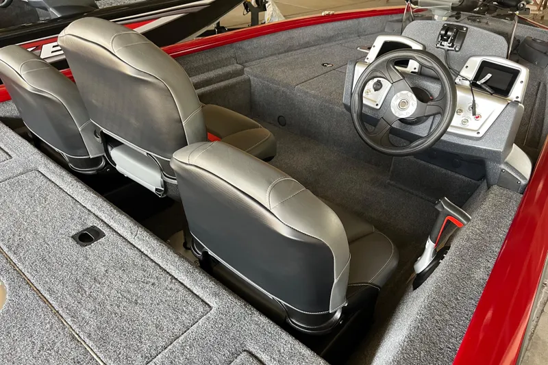 Slide: The Image of 2025 Tracker Pro Team 175 Crappie Edition boat interior with steering wheel and seating. - 5