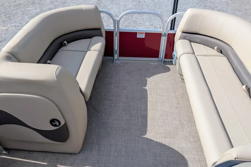 Slide: The Image of 2025 Sun Tracker Party Barge 18 DLX interior with beige seating and carpeted floor. - 6