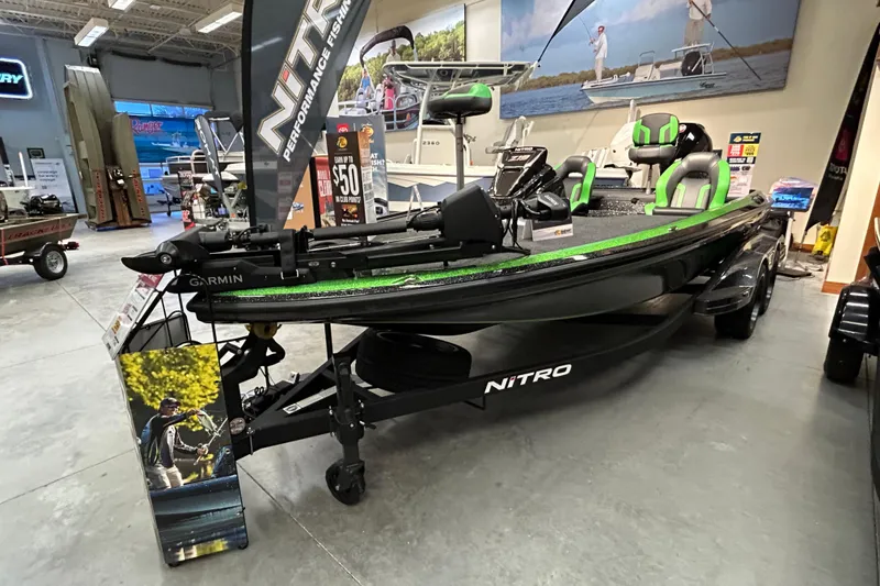 Slide: The Image of 2025 Nitro Z19 fishing boat displayed in showroom with green accents and Garmin equipment. - 1