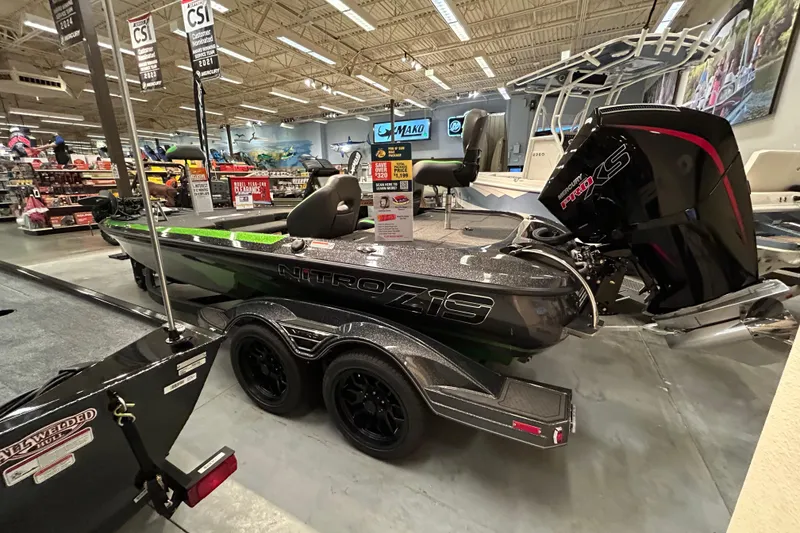 Slide: The Image of 2025 Nitro Z19 boat displayed in showroom with Mercury Pro XS engine. - 2