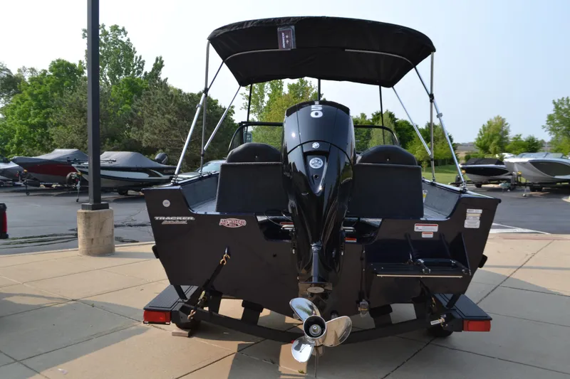 Slide: The Image of 2025 Tracker Pro Guide V-175 Combo boat with outboard motor, parked on a trailer. - 2