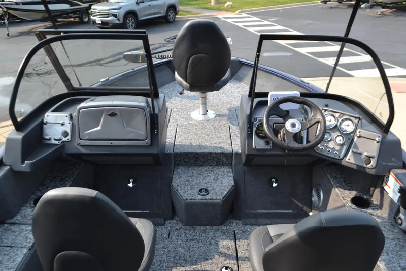 Slide: The Image of 2025 Tracker Pro Guide V-175 Combo boat interior with steering console and seating. - 3