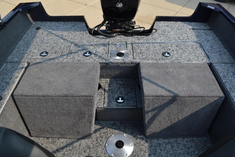 Slide: The Image of 2025 Tracker Pro Guide V-175 Combo boat interior with storage compartments and motor. - 4