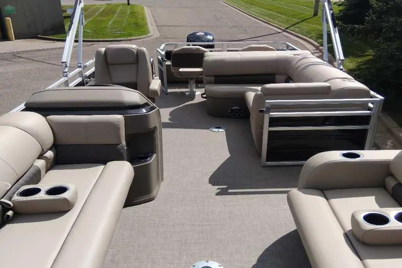 Slide: The Image of 2025 Sun Tracker SportFish 22 DLX pontoon boat with spacious seating and cup holders. - 2