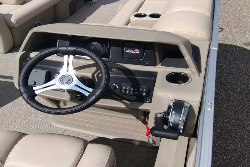 Slide: The Image of 2025 Sun Tracker SportFish 22 DLX boat dashboard with steering wheel and controls. - 4