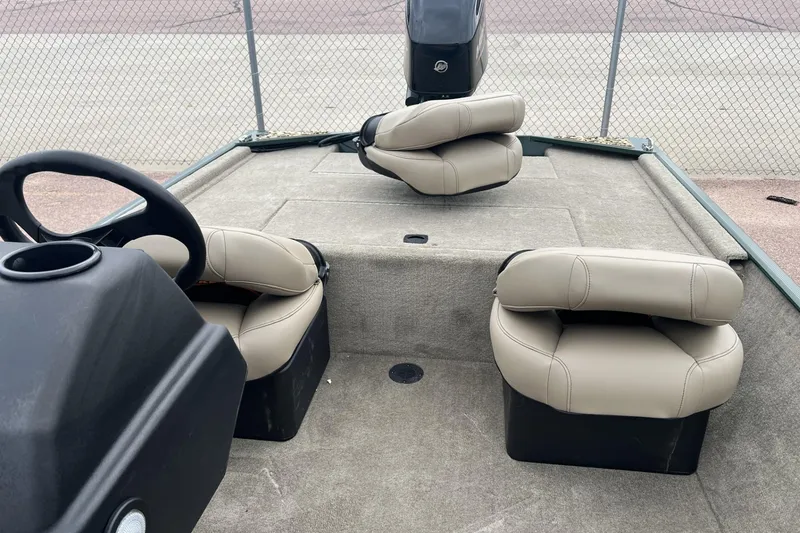 Slide: The Image of 2025 Tracker Bass Tracker Classic Limited boat interior with beige seats and steering console. - 3