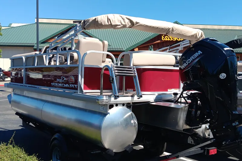 Slide: The Image of 2025 Sun Tracker Party Barge 18 DLX pontoon boat with canopy and outboard motor. - 4
