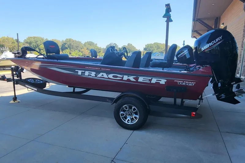 The Image of 2025 Tracker Pro Team 195 Tournament Edition boat on trailer, parked outdoors. - 0