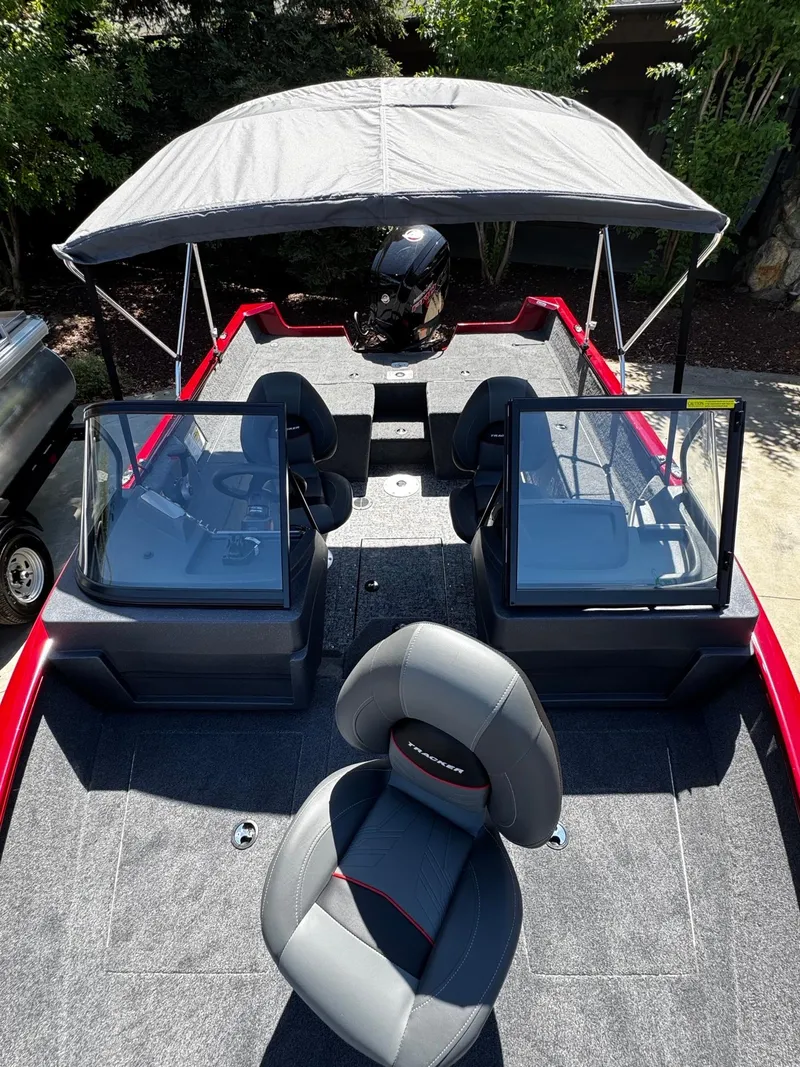 Slide: The Image of 2025 Tracker Pro Guide V-175 Combo boat interior with seating and canopy. - 3