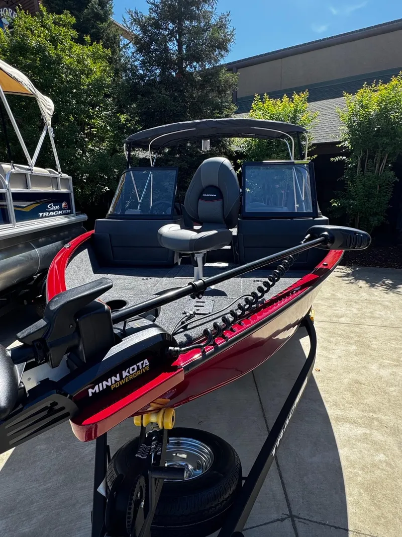 Slide: The Image of 2025 Tracker Pro Guide V-175 Combo boat with Minn Kota PowerDrive, parked outdoors. - 4