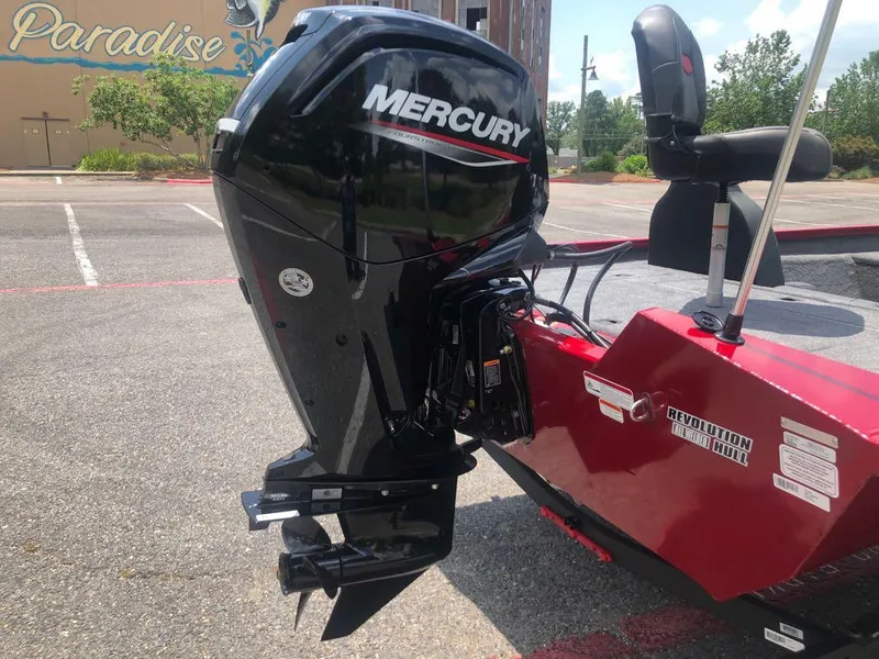 Slide: The Image of 2025 Tracker Pro Team 175 boat with Mercury outboard motor in a parking lot. - 2