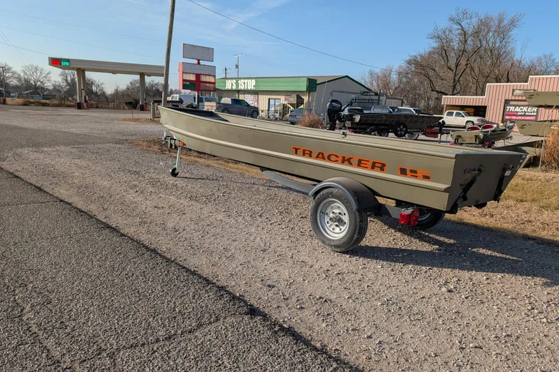 Slide: The Image of 2025 Tracker Grizzly 15 Jon boat on trailer near rural gas station. - 20