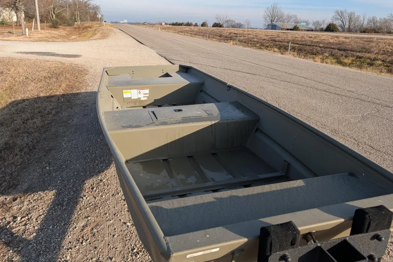 Slide: The Image of 2025 Tracker Grizzly 15 Jon boat parked on a rural roadside. - 30