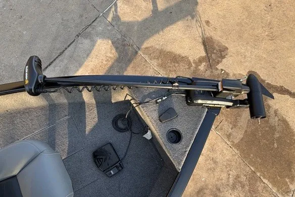 Slide: The Image of Trolling motor on 2025 Tracker Super Guide V-16 T boat, docked on concrete surface. - 13
