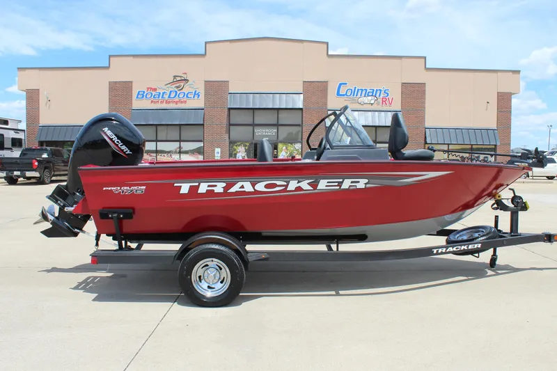 The Image of 2025 Tracker Pro Guide V-175 Combo boat in red, parked outside a dealership. - 0